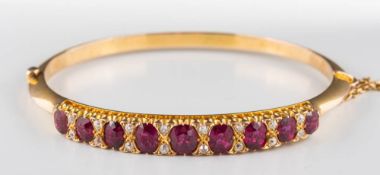 A 19th century ruby and diamond hinged bangle: with graduated,