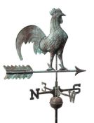 An embossed copper weather vane: in the form of a cockerel perched on an arrow,