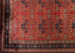 A Derbend carpet:, the brick red field with all over geometric medallions with rams horn, boteh,