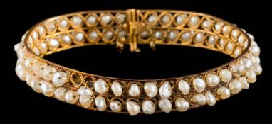 A freshwater pearl hinged bangle: with safety chain, approximately 16.5gms gross weight.