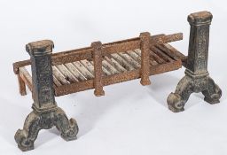 A pair of 19th century cast andirons: of traditional design and a fire basket. 56cm. wide.