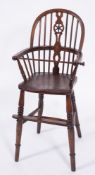 A child's early 19th Century elm, ash and beech Windsor wheel and stick back high chair:,