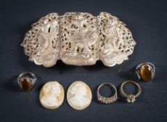 An Eastern silver three-division belt buckle,: two amber mounted rings,
