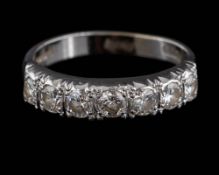 An 18ct white gold and diamond seven-stone ring: with round,