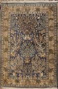 A Kashmir rug:, the pastel blue field with a design of flowering trees and shrubs,