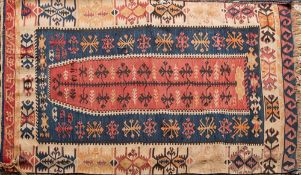 A Kelim flatweave:, the brick red field with a geometric leaf design,