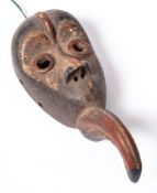 A small painted West African wood monkey face mask: with polychrome decoration, 20cm. high.