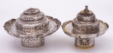 A Chinese silver and gilded candle holder and cover,
