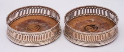 A pair of Elizabeth II silver wine coasters, maker A Chick & Sons Ltd, London,