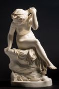 A Copeland parian figure 'Water Nymph': the naked girl seated on a rocky mound with her lower body