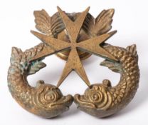 A cast bronze door knocker: in the form of two dolphins supporting a Maltese cross 15cm high.