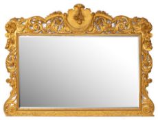 A carved giltwood overmantel mirror:, of large size,