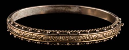 A 9ct gold hinged bangle: of bead work design approximately 9gms gross weight.
