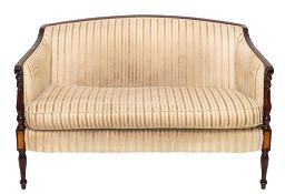 An Edwardian mahogany settee:, with an arched upholstered back,