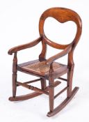 A child's Victorian cane seat commode chair and a cane seat chair.