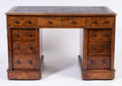 A Victorian walnut pedestal desk:, the rectangular top inset with a panel of tooled leather,