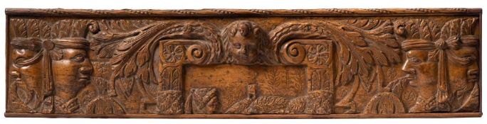 A late 17th/ early 18th Century carved fruitwood panel: the central cartouche with winged angels