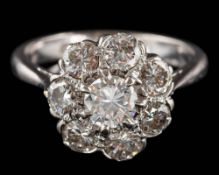 A diamond floral cluster ring: set with eight round brilliant-cut diamonds estimated to weigh a