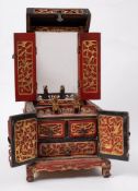 A Chinese carved and parcel gilt softwood table top toiletry chest: the hinged lid decorated with
