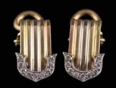 A pair of diamond set buckle style ear-clips: stamped '750' , approximately 0.