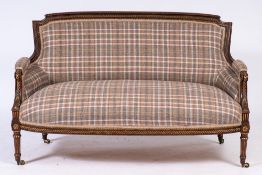 A late 19th Century French carved walnut and partly gilt settee:,