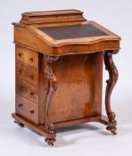 A Victorian walnut serpentine fronted Davenport:,