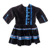 A late Victorian child's velvet dress : with blue buttons to the front and cuffs and banded pleated