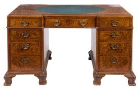A burr figured walnut pedestal desk:, of recessed broken outline,