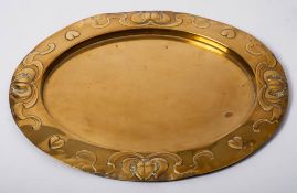 An Art Nouveau period brass oval tray: with embossed heart, flower and sinuous scroll decoration,
