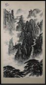 A Chinese painting, signed Guanyi [Kai Pingzhou]: depicting a mountainous landscape with waterfall,