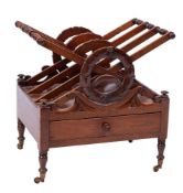 An early 19th Century mahogany X frame four division Canterbury:, with carved laurel wreath,