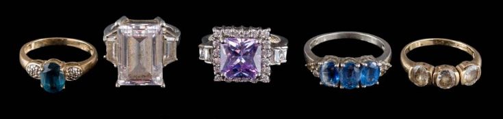 A 9ct gold blue stone-set ring, a 9ct gold three-stone ring and three dress rings.