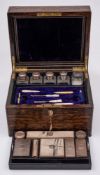 A Victorian coromandel wood and brass mounted toiletry box: the hinged lid with mirror and