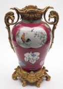 A Chinese ormolu-mounted famille rose ruby-ground vase: of ogee form, painted with fan, scroll,