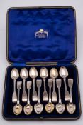 A matched set of twelve silver Fiddle pattern egg spoons, various makers and dates: crested, cased,