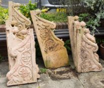 A set of seven Indian sandstone balcony supports: each carved with scrollwork,