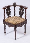 A 19th Century Continental carved and stained beech corner elbow chair:,
