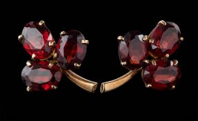 A pair of 9ct gold and garnet mounted three leaf clover ear studs: each approximately 19mm long.