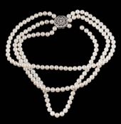 A cultured pearl three-string necklace: the cultured pearls measure an average of 6.