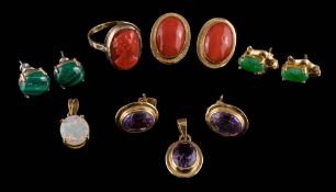 A pair of oval coral mounted ear clips stamped '750',: a carved coral ring,