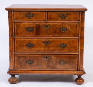 An early 18th Century yew-wood and walnut veneer fronted chest:,