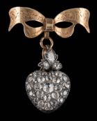 A late 19th century diamond pendant locket: the heart-shaped pendant pave-set with old