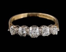 A graduated diamond five-stone ring: set with round and cushion-shaped diamonds estimated to weigh