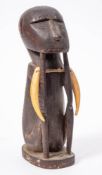 An African carved monkey figure: seated with his elbows on his knees, 25cm. high.