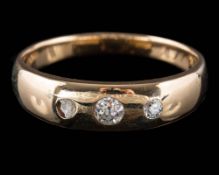 A gold and three-stone diamond band: with graduated old-cut diamonds estimated to weigh a total of