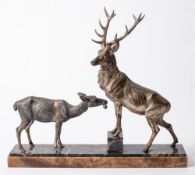 After Louis Carvin, an Art Deco period metal study of a stag and doe: on a stepped rectangular base,