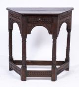 A 17th Century oak credence table:, with a plain canted top,