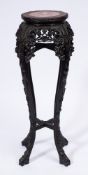 A Chinese carved hardwood circular jardiniere stand:, of similar design,
