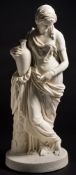 A Copeland parian figure of Rebekah after William Theed: standing full length by a palm,
