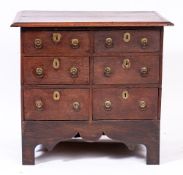 An unusual 18th Century oak chest of small size:, with a rectangular moulded top,